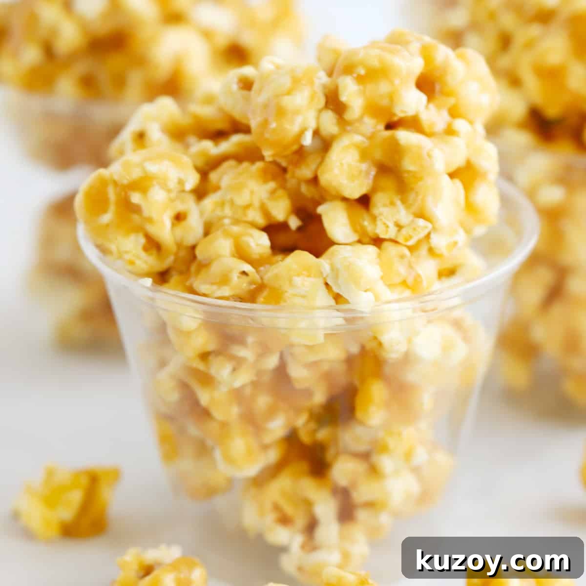 How to Make Classic Homemade Caramel Candy at Home 11 Caramel popcorn inside plastic cups on a table.