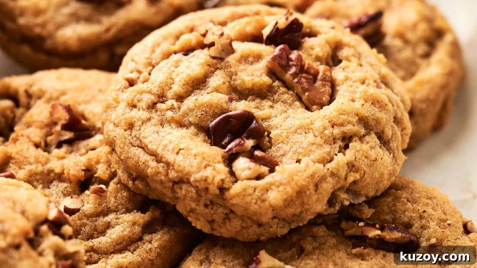 33 Must-Bring Thanksgiving Potluck Recipes for Every Year 28 Close-up of freshly baked cookies with nuts on top, arranged closely together.