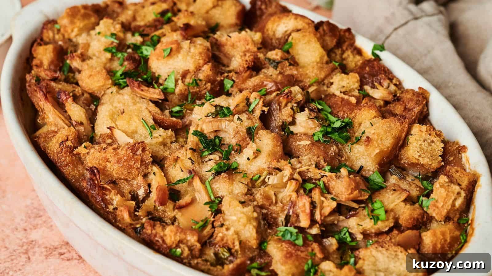 33 Must-Bring Thanksgiving Potluck Recipes for Every Year 10 A golden brown Thanksgiving casserole of baked stuffing garnished with fresh herbs.