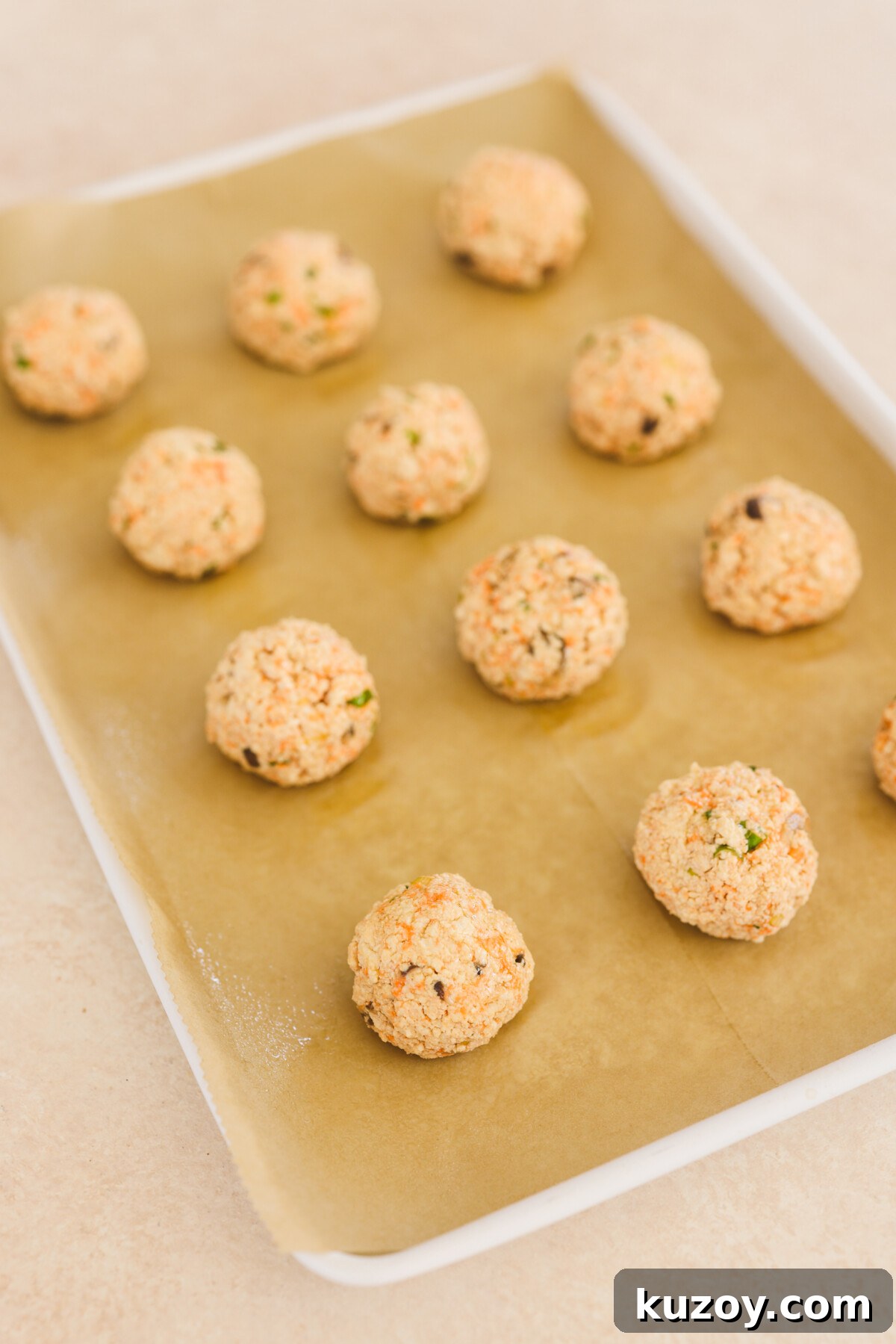 meatballs on a baking sheet lined with parchment paper