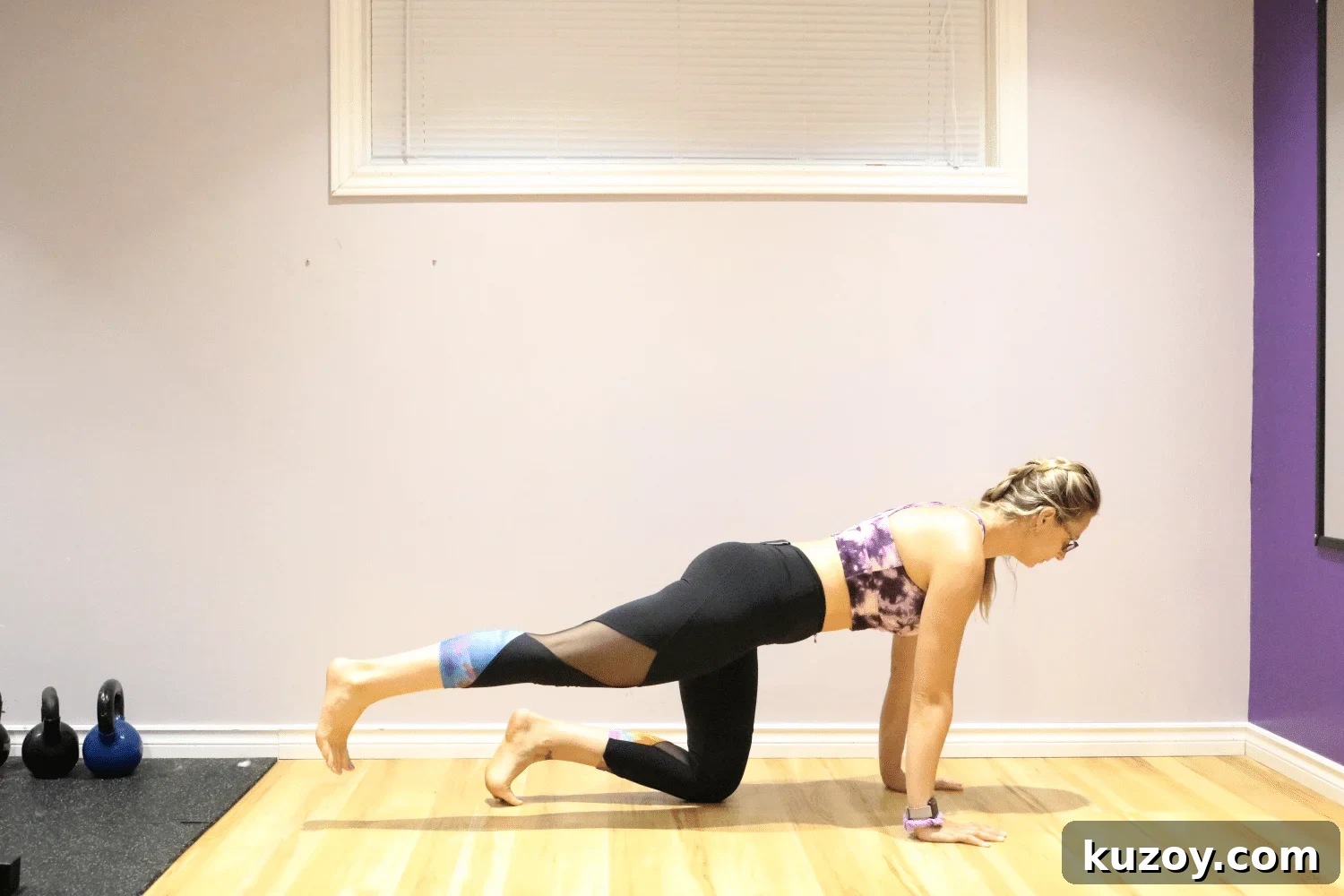Woman performing a glute kickback on the floor