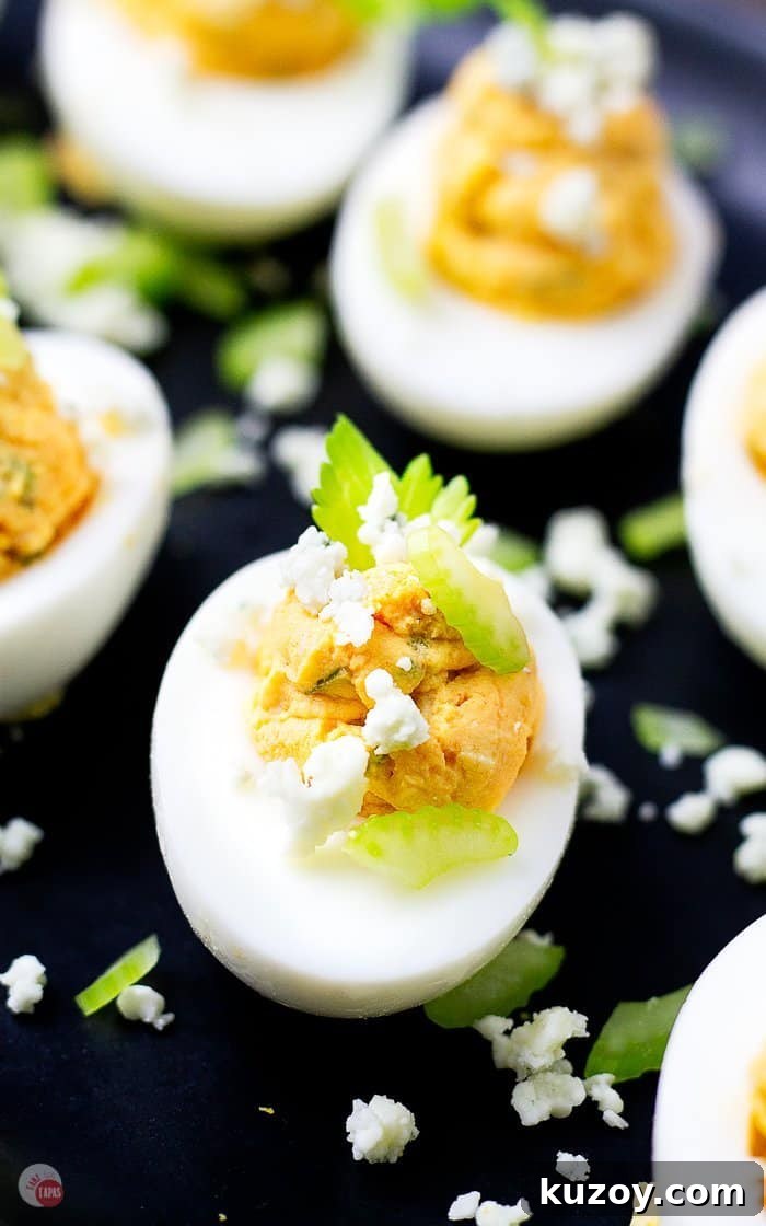 Buffalo Chicken Deviled Eggs Recipe for Game Day or Parties 6 sliced celery leaves and crumble blue cheese garnish eggs