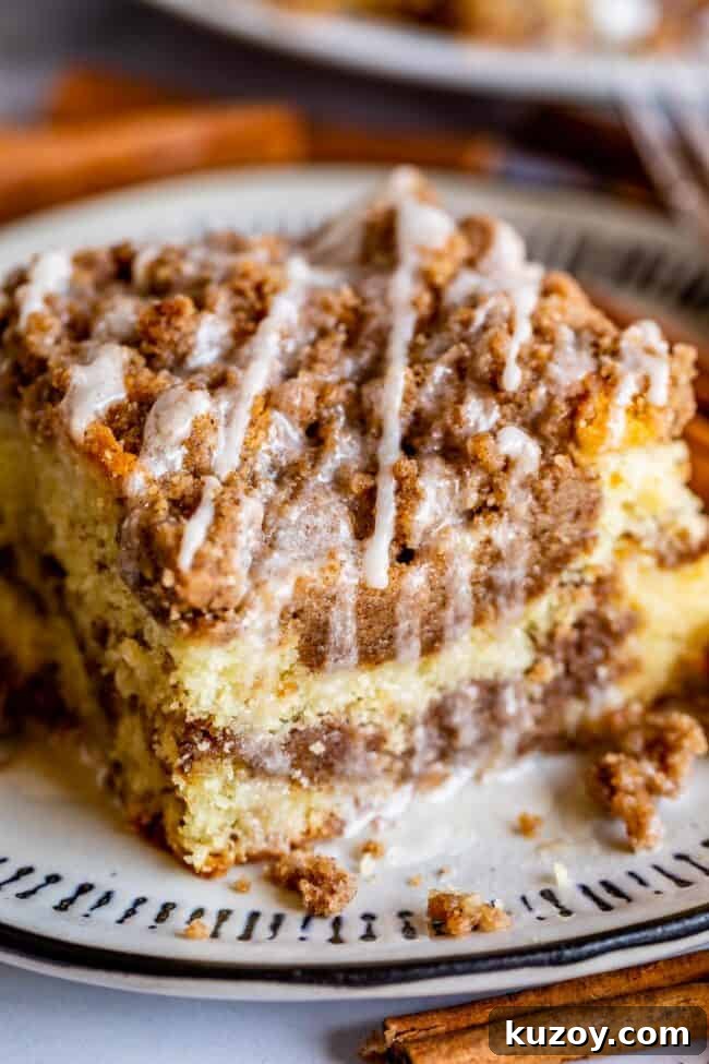 Sour Cream Coffee Cake, with a Ridiculous Amount of Streusel slice of sour cream coffee cake drizzled with vanilla icing.