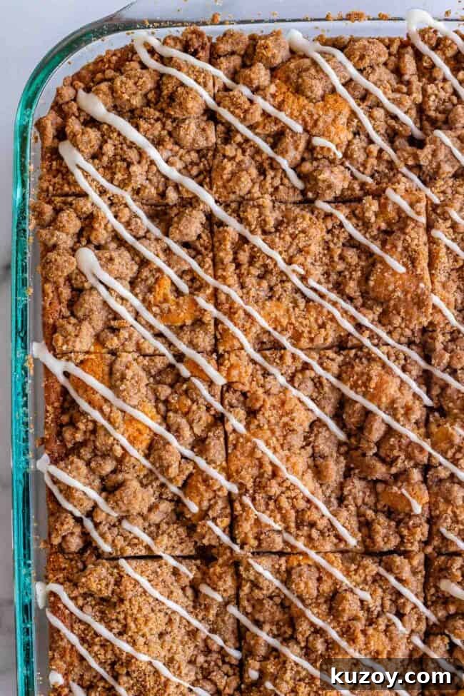 Sour Cream Coffee Cake in a pan Streusel coffee cake in a 9x13 inch pan with diagonal drizzles of vanilla icing.