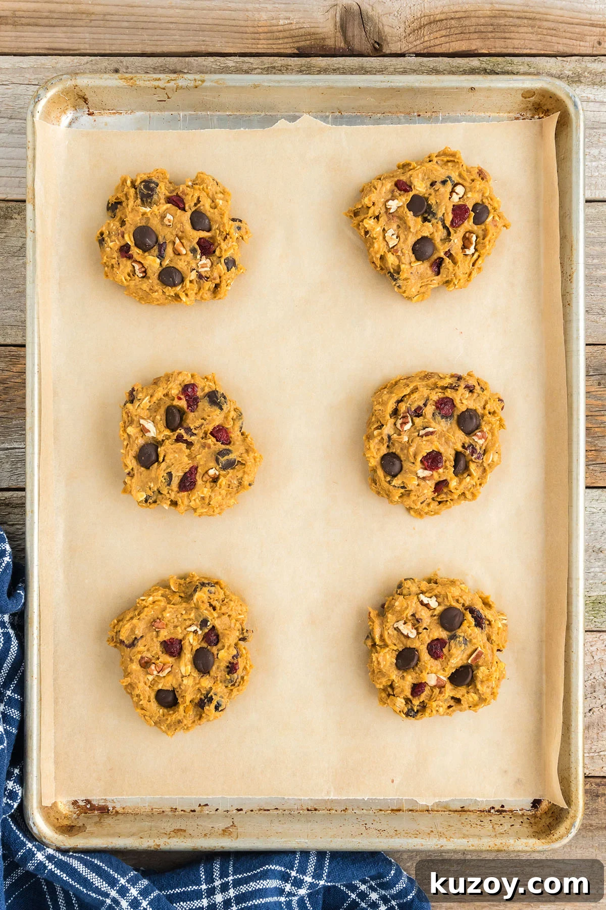 Pumpkin Oat Breakfast Cookies — Ready in 30 Minutes 9 Pumpkin Breakfast Cookies on a parchment paper lined baking sheet.