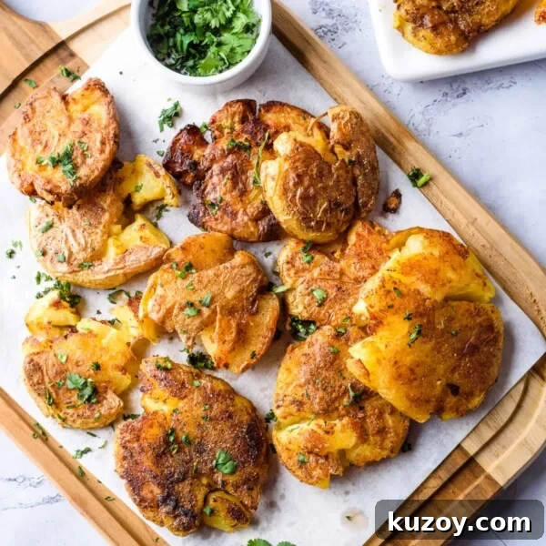 Close up image of garlic smashed potatoes on wooden platter.