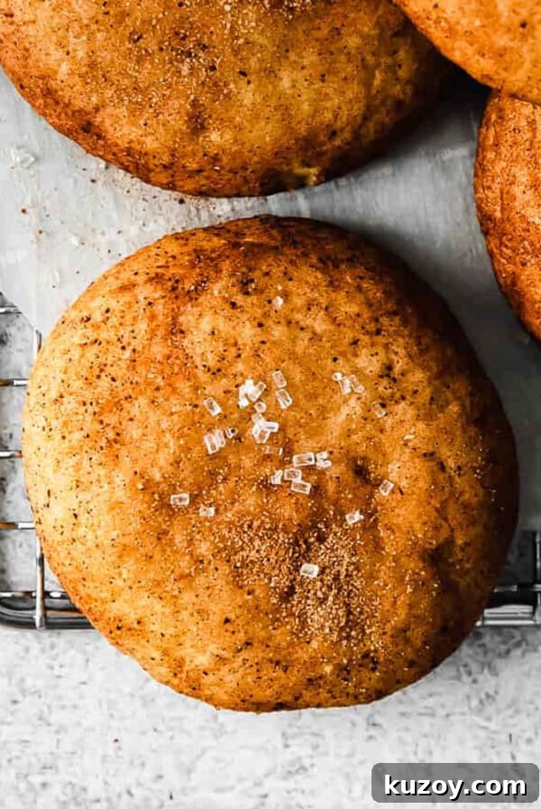 Chewy Tahini Cookies Recipe with Golden Sesame Flavor 5 Four cinnamon buns on a cooling rack.