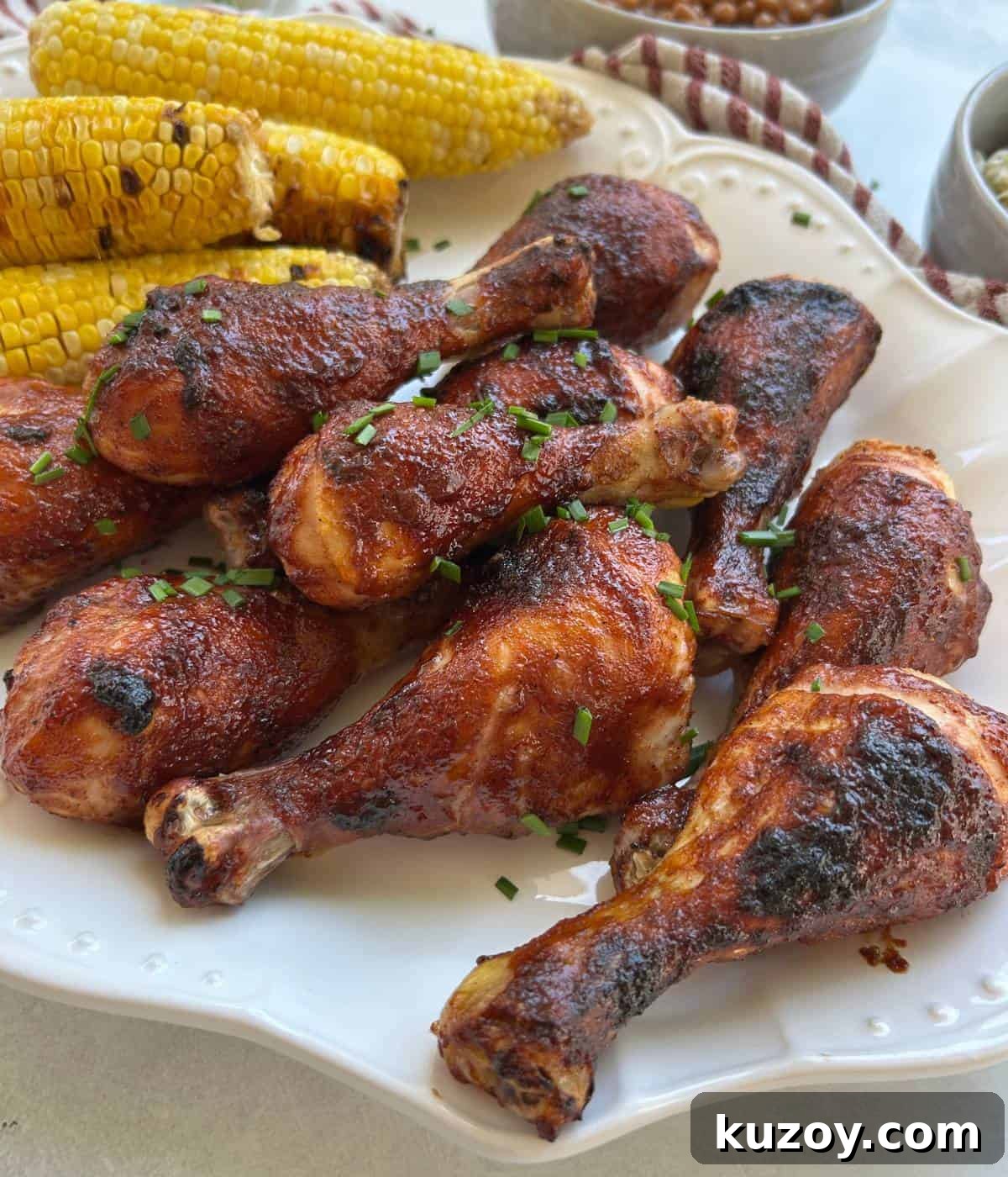 Crispy Oven-Baked BBQ Chicken Drumsticks Recipe 2 BBQ chicken drumsticks on platter.