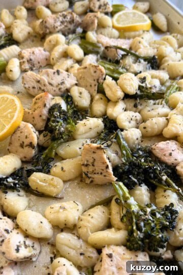Gnocchi, broccolini and chicken on cookie sheet.