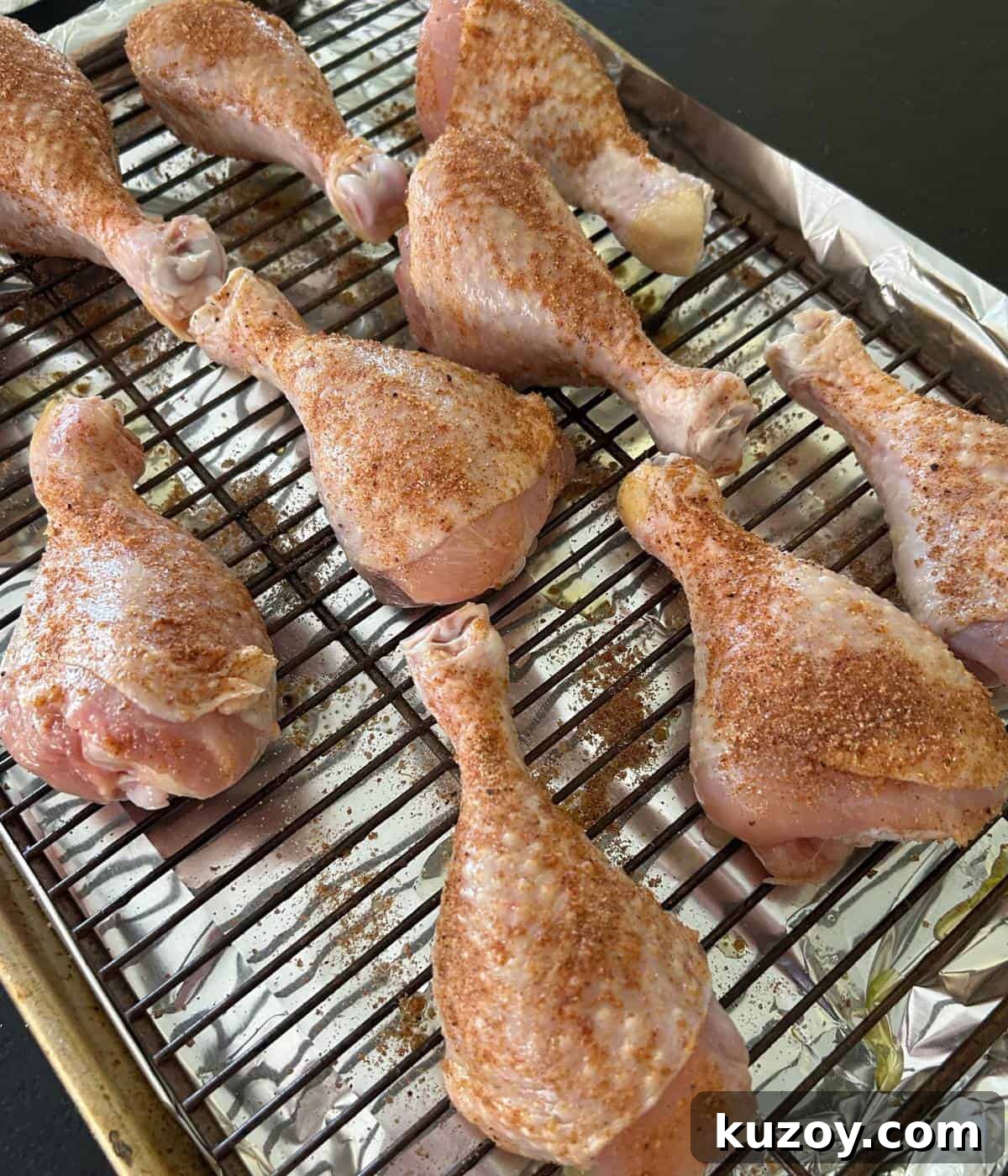 Crispy Oven-Baked BBQ Chicken Drumsticks Recipe 5 Seasoned bbq chicken drumsticks on rack.