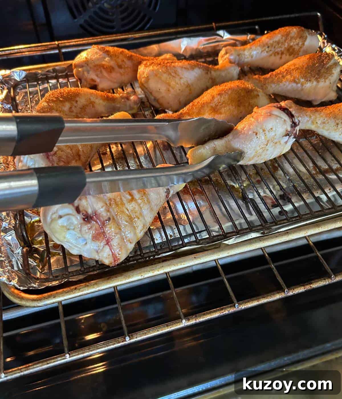 Crispy Oven-Baked BBQ Chicken Drumsticks Recipe 6 Flipping chicken drumsticks.