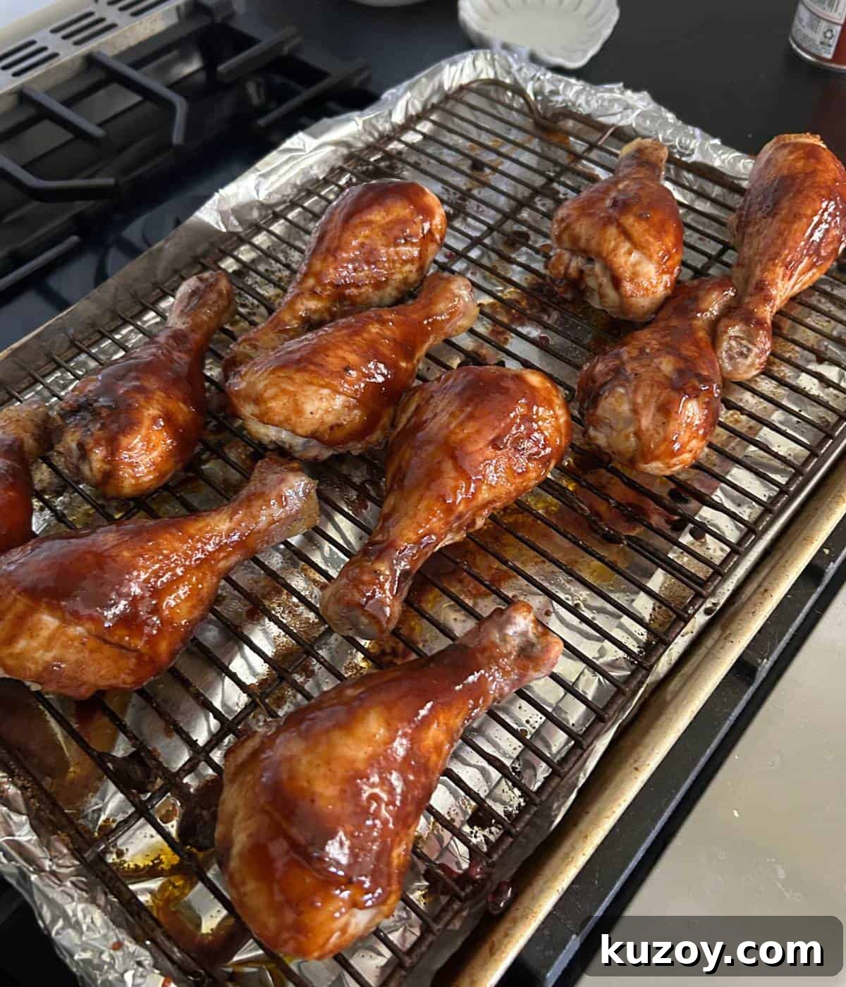 Crispy Oven-Baked BBQ Chicken Drumsticks Recipe 7 BBQ Sauce over chicken drumsticks.