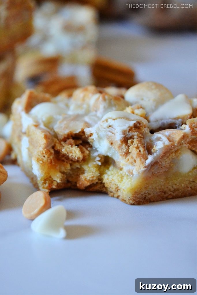 closeup photo of a white choc nutter butter magic bar with a bite missing