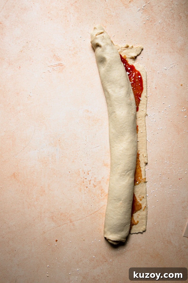 A rolled dough filled with strawberry filling.