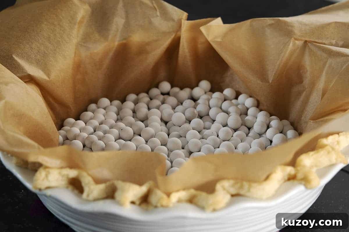 Flaky Lard Pie Crust Recipe for Perfect Homemade Pies 12 lard pie crust baked with parchment and pie weights