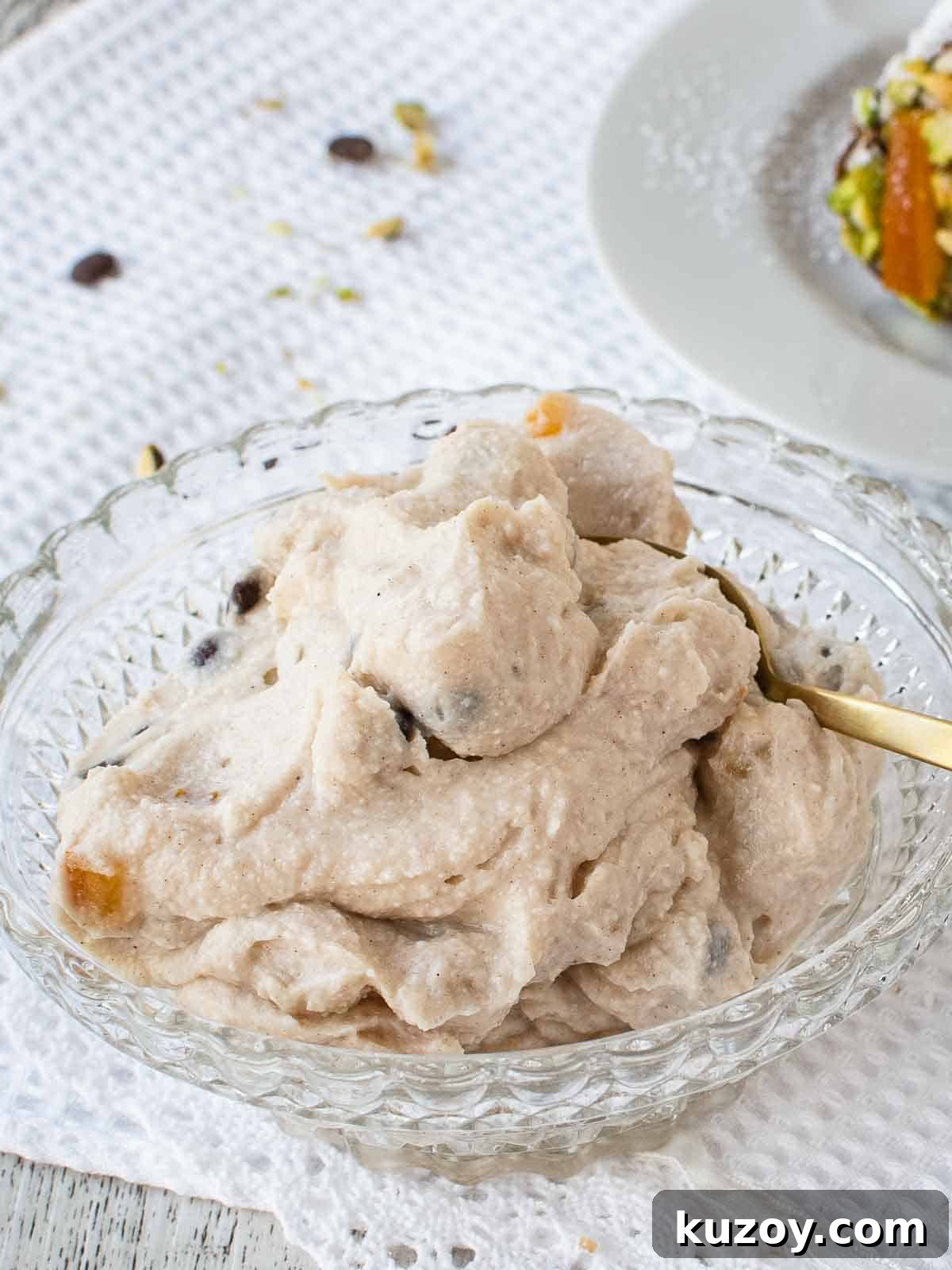 How to Make Classic Cannoli Filling at Home 2 Cannoli filling in a glass bowl with gold spoon.