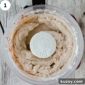 How to Make Classic Cannoli Filling at Home 4 Creamy mixture in a food processor with the lid removed viewed from above.