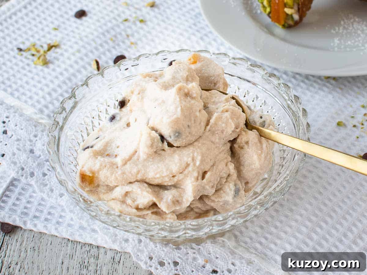 How to Make Classic Cannoli Filling at Home 6 Bowl of creamy mixture with gold spoon.