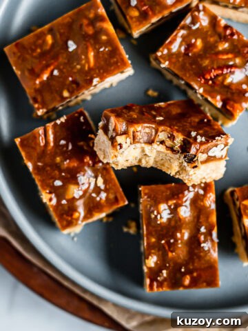 Caramel pecan bars on a blue plate.