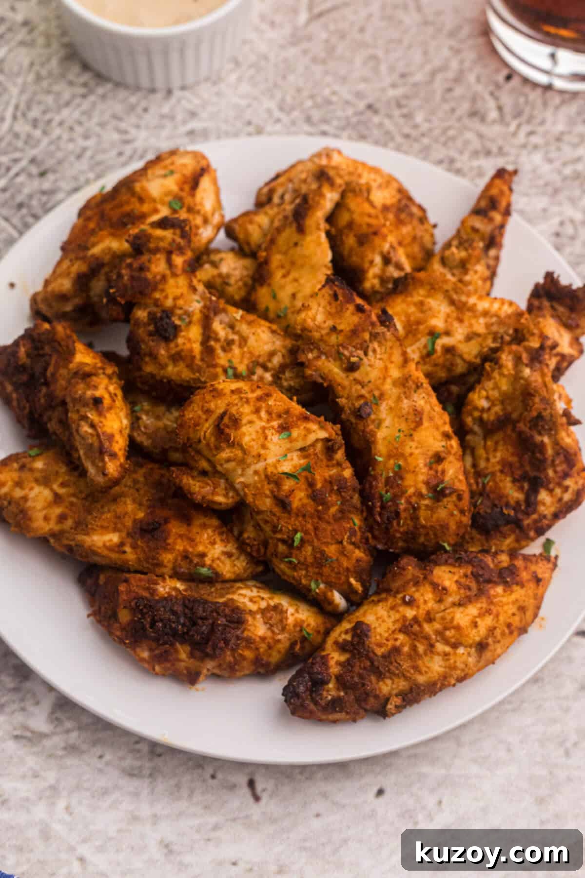 Crispy Air Fryer Blackened Chicken Tenders 2 Air fryer blackened chicken tenders served on a white plate.