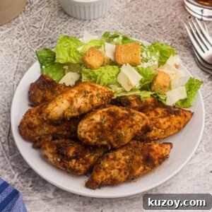 Crispy Air Fryer Blackened Chicken Tenders 8 Blackened chicken served on a white plate with a salad.
