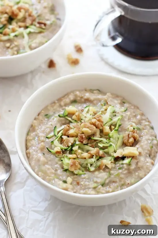 Perfectly creamy zucchini bread steel cut oatmeal! This healthy breakfast is filled with rich vanilla, warm cinnamon and shredded zucchini! Vegan and gluten free! Two bowls of Zucchini Bread Steel Cut Oatmeal with a cup of coffee in the background.