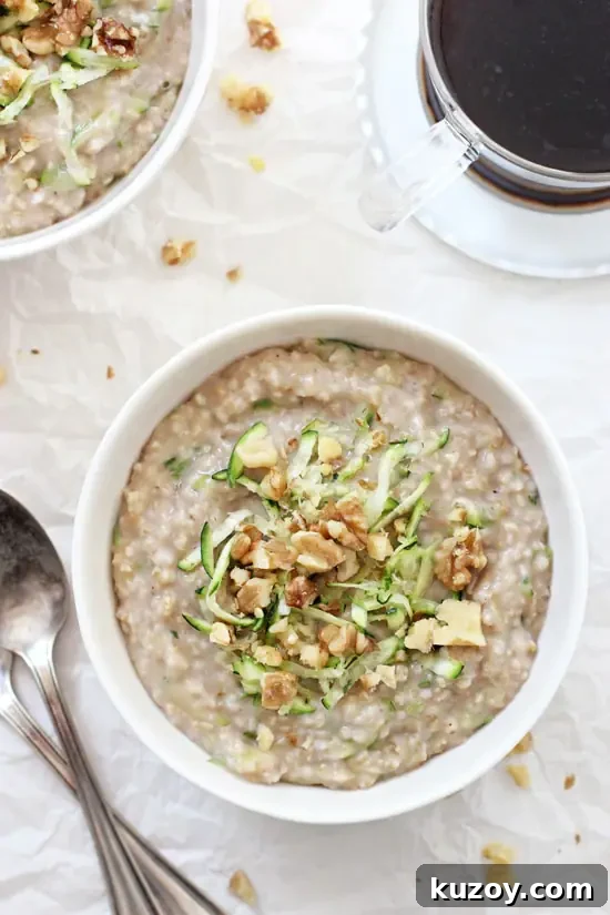 Perfectly creamy and chewy zucchini bread steel cut oatmeal! Healthy and hearty! And packed with vanilla, cinnamon, maple syrup and shredded zucchini! An overhead view of two bowls of Zucchini Bread Steel Cut Oatmeal with coffee off to the side.