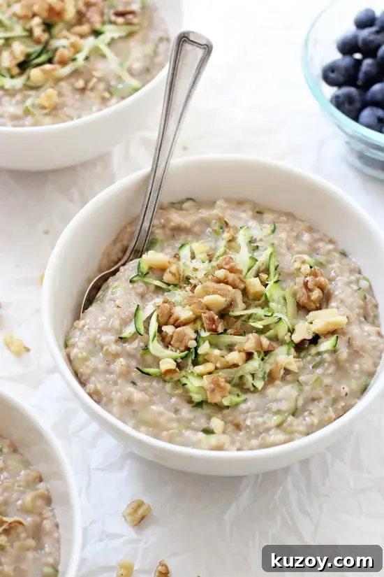 Stovetop zucchini bread steel cut oatmeal! Filled with vanilla, cinnamon and plenty of shredded zucchini, it’s a hearty and healthy breakfast! Gluten free and vegan! Three bowls of Zucchini Bread Steel Cut Oatmeal with blueberries off to the side.