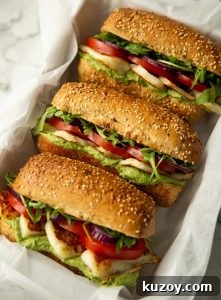 Halloumi Sandwich 3 halloumi sandwiches in large white dish on marble background