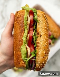 Halloumi Sandwich over head close up shot of hand holding halloumi sandwich showing filling