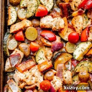 One-Pan Roasted Chicken with Seasonal Vegetables 5 top close up shot of cooked chicken and vegetables on a sheet pan