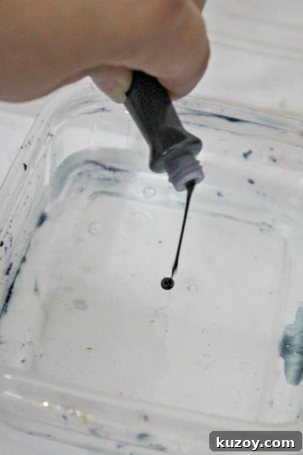 Galaxy Slime Recipe: Step-by-Step Guide for Sparkling Space Slime 7 adding food coloring to slime