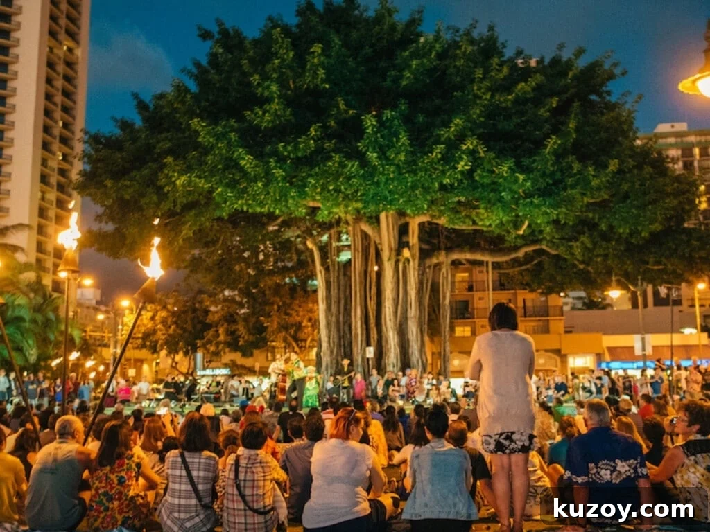 Waikīkī Live Music & Hula Show Guide (Updated 2026) 3 Crowd watching outdoor hula show under the banyan tree at Kūhiō Beach Hula Mound.