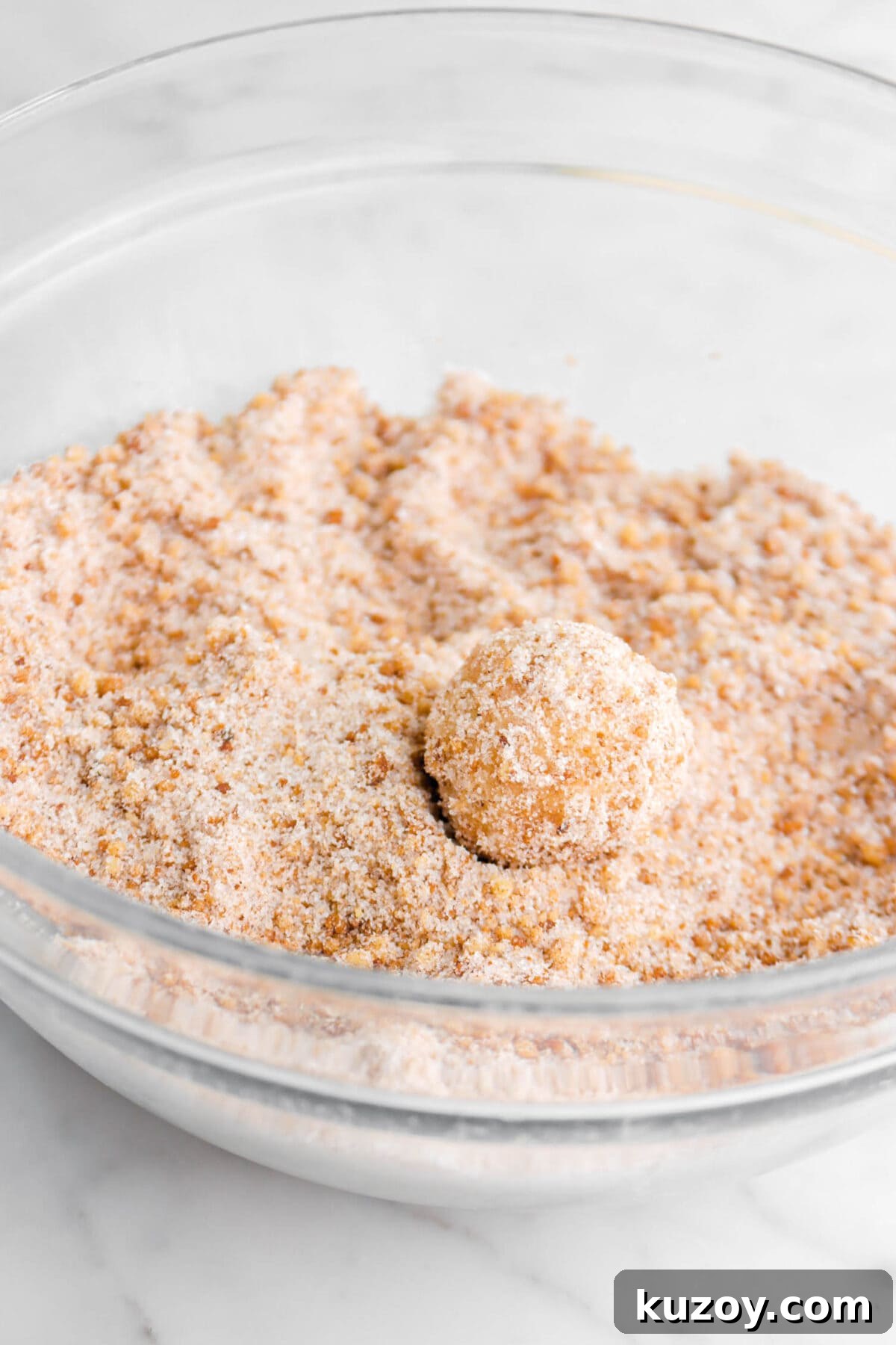 Cinnamon Sugar Walnut Pull-Apart Bread Recipe 19 dough ball covered in cinnamon sugar in glass bowl