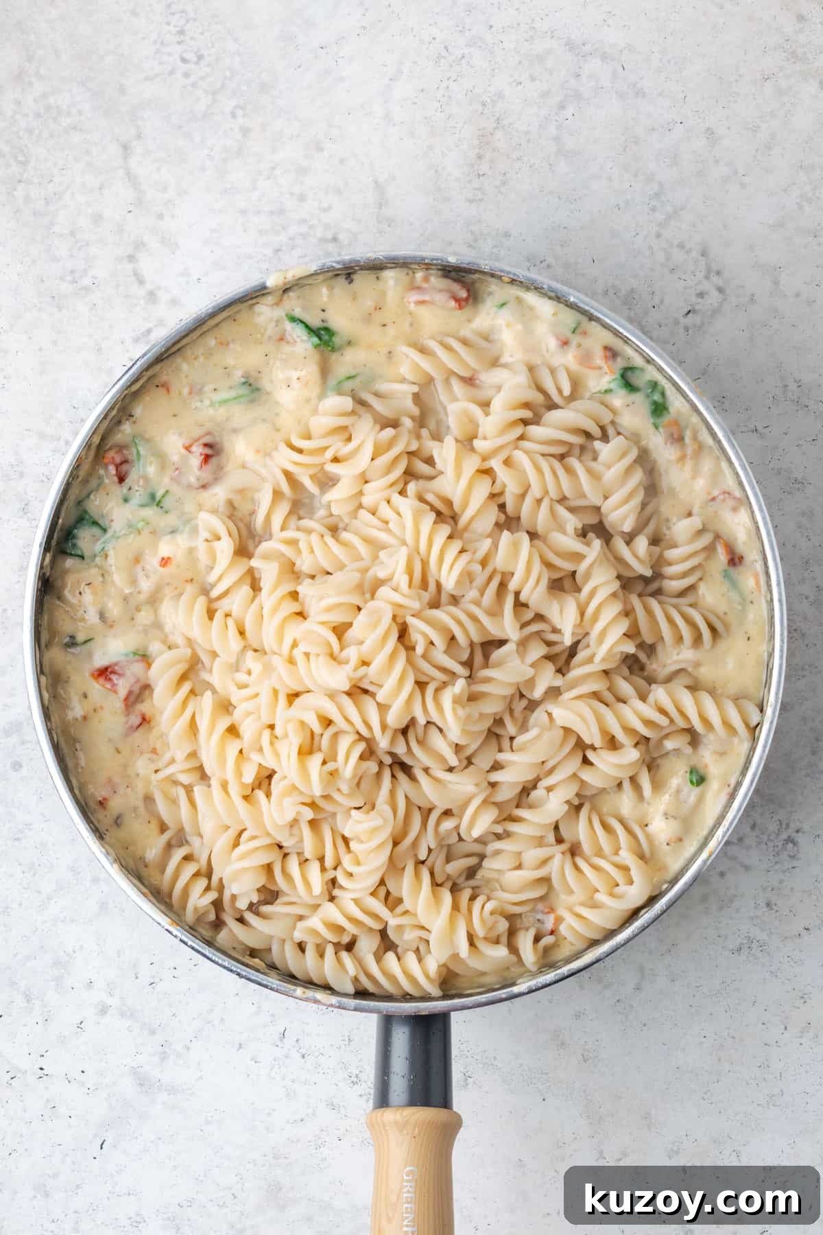 30-Minute Marry Me Chicken Pasta Recipe for Date Night 13 Cooked pasta added to the saute pan with the chicken and sauce.