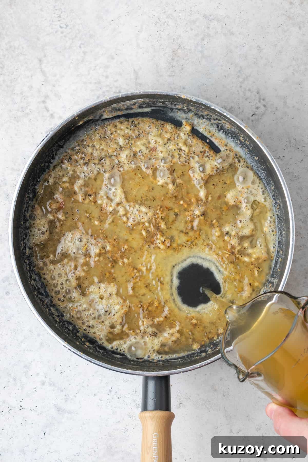 30-Minute Marry Me Chicken Pasta Recipe for Date Night 9 Chicken broth being poured into the saute pan with the roux.