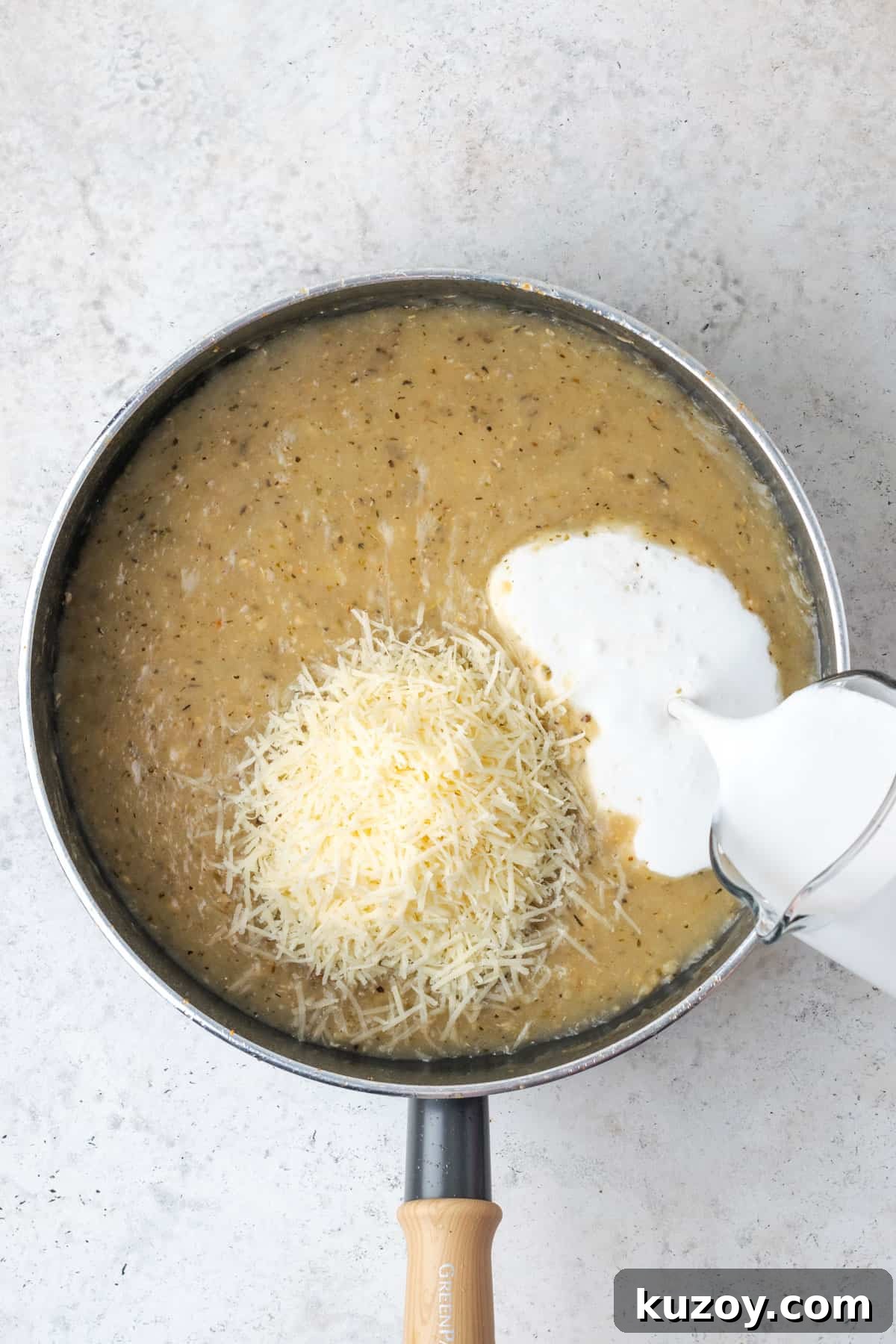 30-Minute Marry Me Chicken Pasta Recipe for Date Night 10 Parmesan cheese and cream being added to the garlic sauce.