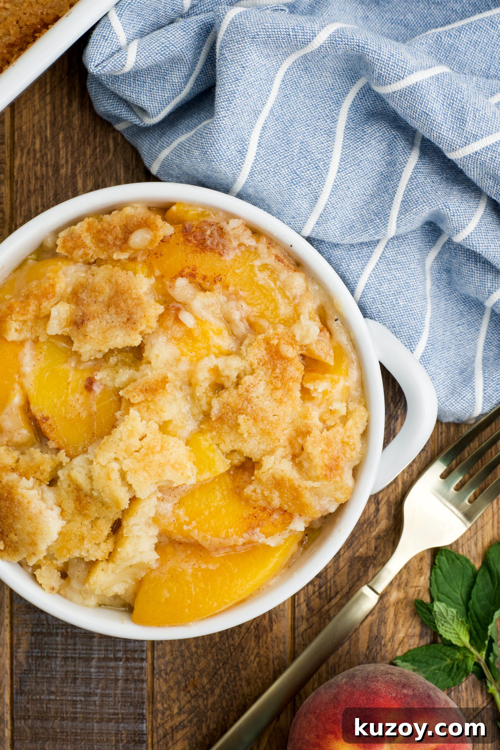 No-Bake Peach Dump Cake Recipe for Quick Summer Dessert 13 Overhead view of a serving of Peach Dump Cake in a white bowl.