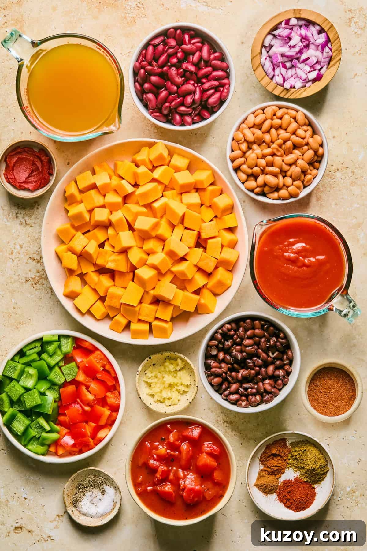 Hearty Butternut Squash & White Bean Chili Recipe 3 Beans, broth, cubed butternut squash, peppers and other ingredients on surface.