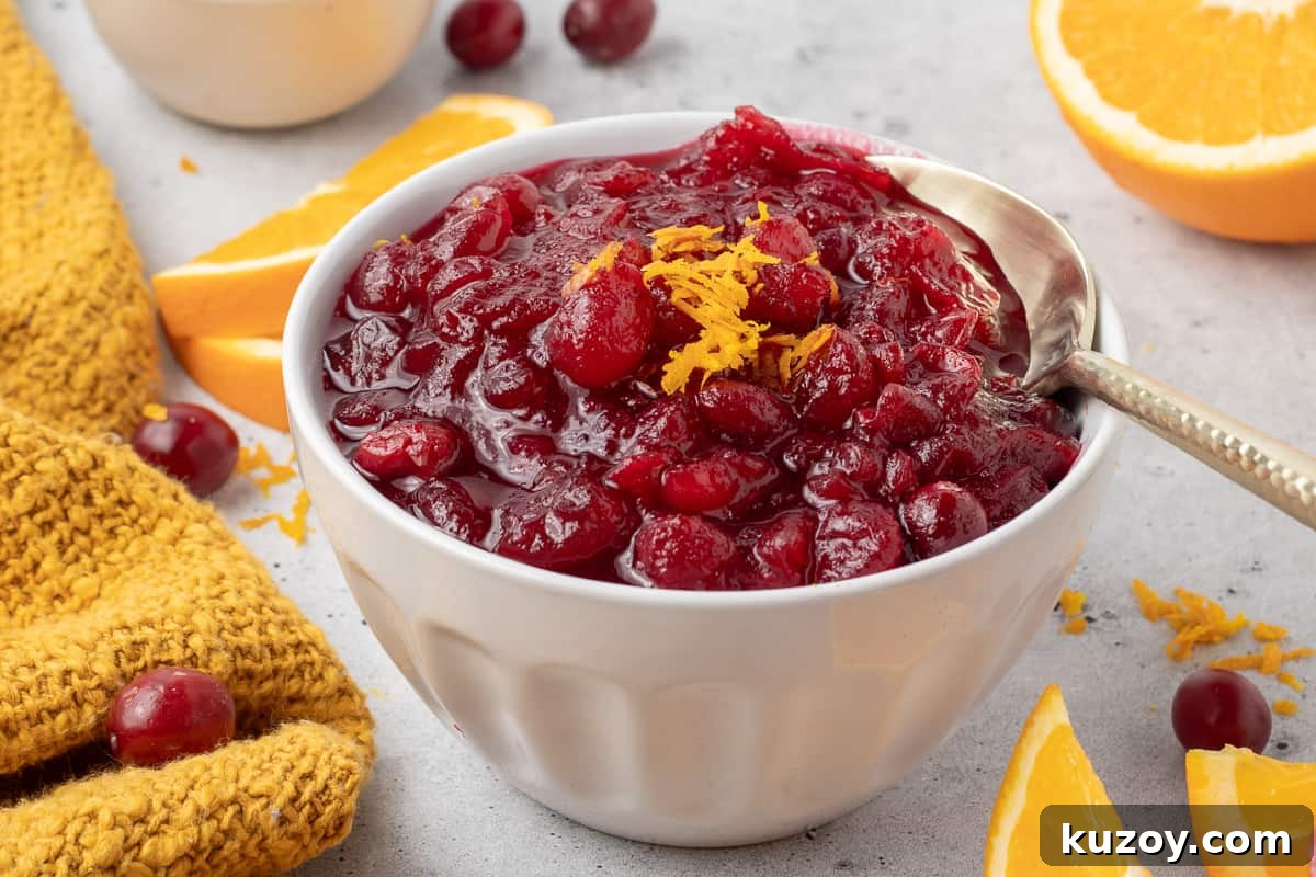 Citrus Cranberry Sauce Recipe: Orange-Infused Holiday Cranberry Sauce 5 A small mason jar filled with cranberry sauce and topped with orange zest.