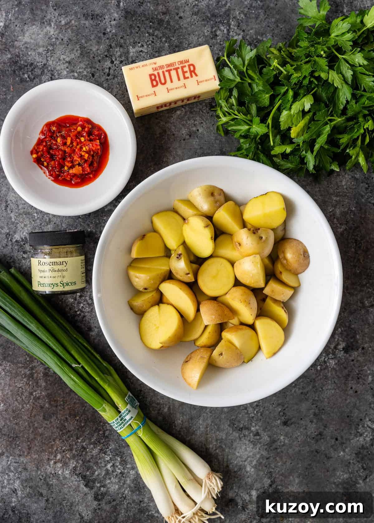 overhead: ingredients to make potatoes and peppers in bowls on a counter