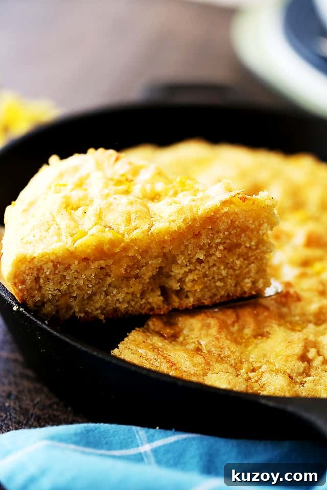 This skillet cornbread recipe is made from scratch and loaded with cheese and sweet corn. Crispy on the edges and fluffy on the inside! Cornbread filled with sweet corn and cheese is served straight from a cast iron skillet.