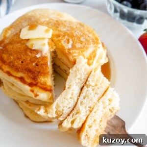 Fluffy Greek Yogurt Pancakes for Light, Protein-Packed Breakfast 15 A bite of fluffy Greek yogurt pancakes on a fork.