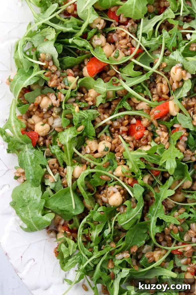 Rye Berry Salad with Chickpeas, Roasted Red Peppers & Arugula 2 Rye berry salad with roasted peppers and arugula on a platter