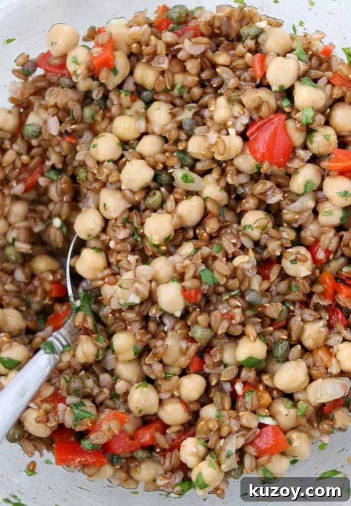 Rye Berry Salad with Chickpeas, Roasted Red Peppers & Arugula 5 rye berries, chickpeas and roasted red peppers tossed together in a bowl with a spoon