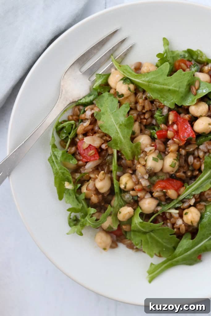 Rye Berry Salad with Chickpeas, Roasted Red Peppers & Arugula 6 rye berry and chickpea with arugula on a plate