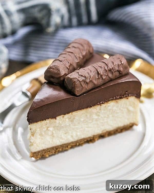 Twix Cheesecake - A dream cheesecake for chocolate and caramel lovers! Twix Cheesecake slice on a white dessert plate.