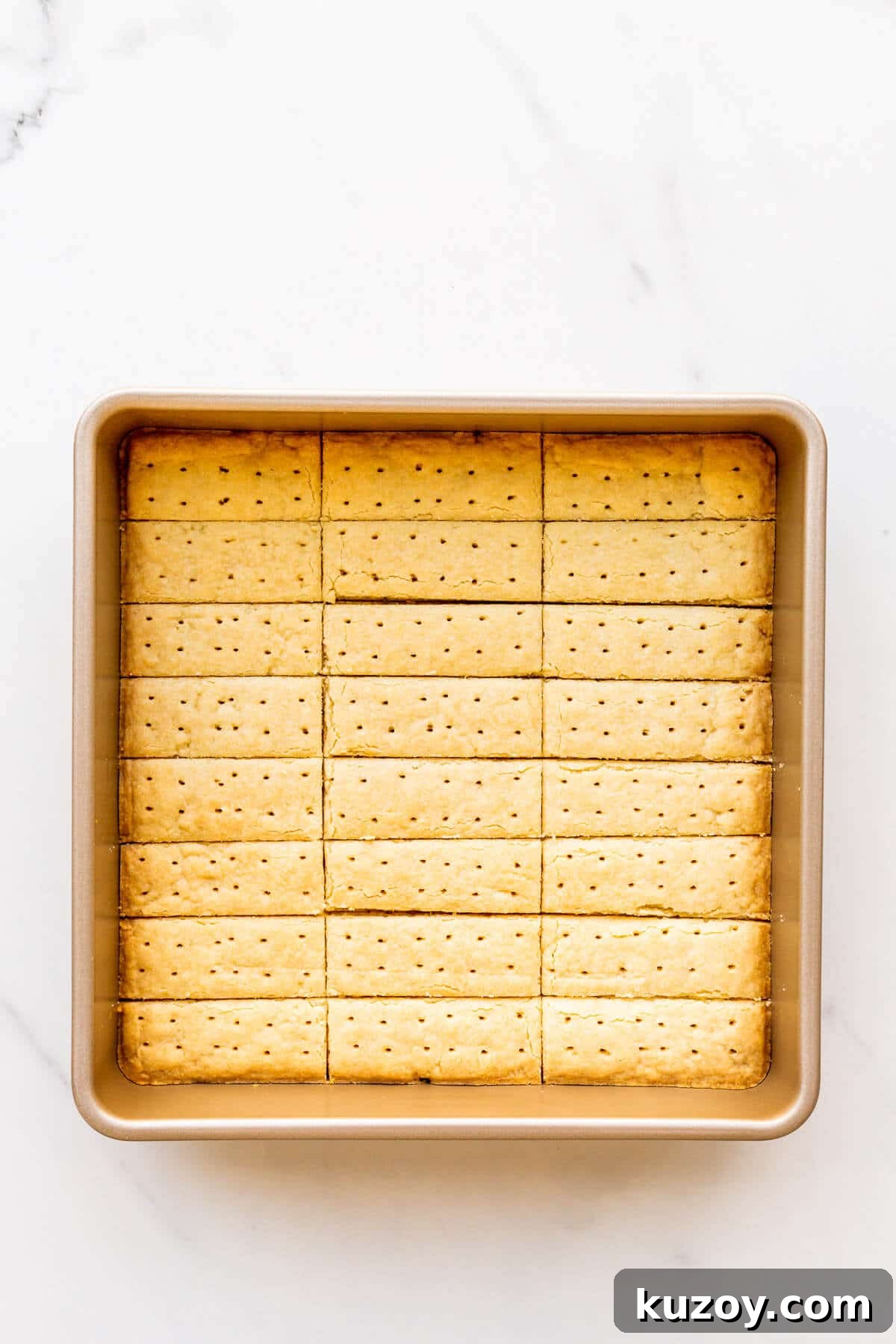 Simple 1-2-3 Shortbread Cookies Recipe for Perfect Crunch 5 Freshly baked shortbread cookies in a square baking pan, cut into sticks and ready to unmould.