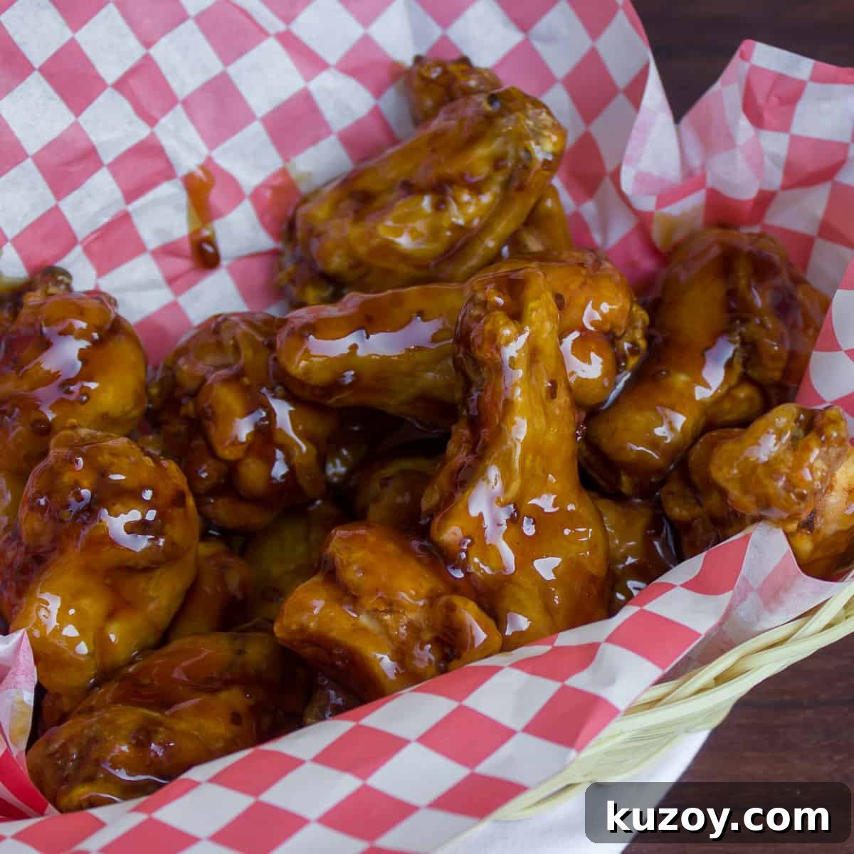 Sticky Honey Garlic Chicken Wings Recipe (Crispy & Flavorful) 8 Deep fried chicken wings in a basket.