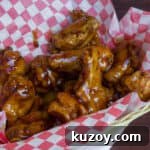 Sticky Honey Garlic Chicken Wings Recipe (Crispy & Flavorful) 9 Deep fried chicken wings in a basket.